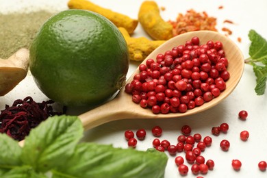 Photo of Different aromatic spices, lime and herbs on white background, closeup