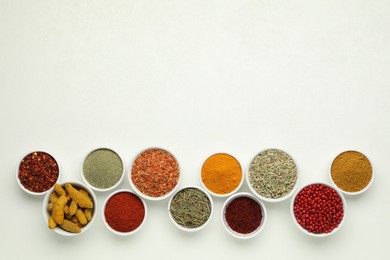 Different aromatic spices and herbs on white background, flat lay