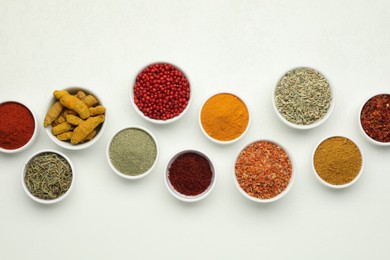 Different aromatic spices and herbs on white background, flat lay