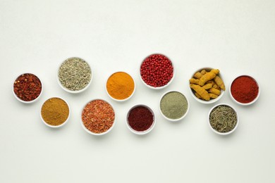 Different aromatic spices and herbs on white background, flat lay