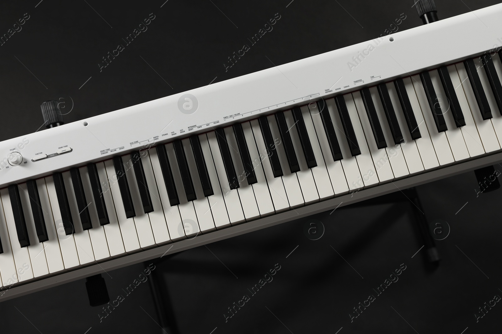 Photo of Synthesizer on black background, top view. Electronic musical instrument