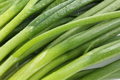 Photo of Many fresh green onions as background, closeup