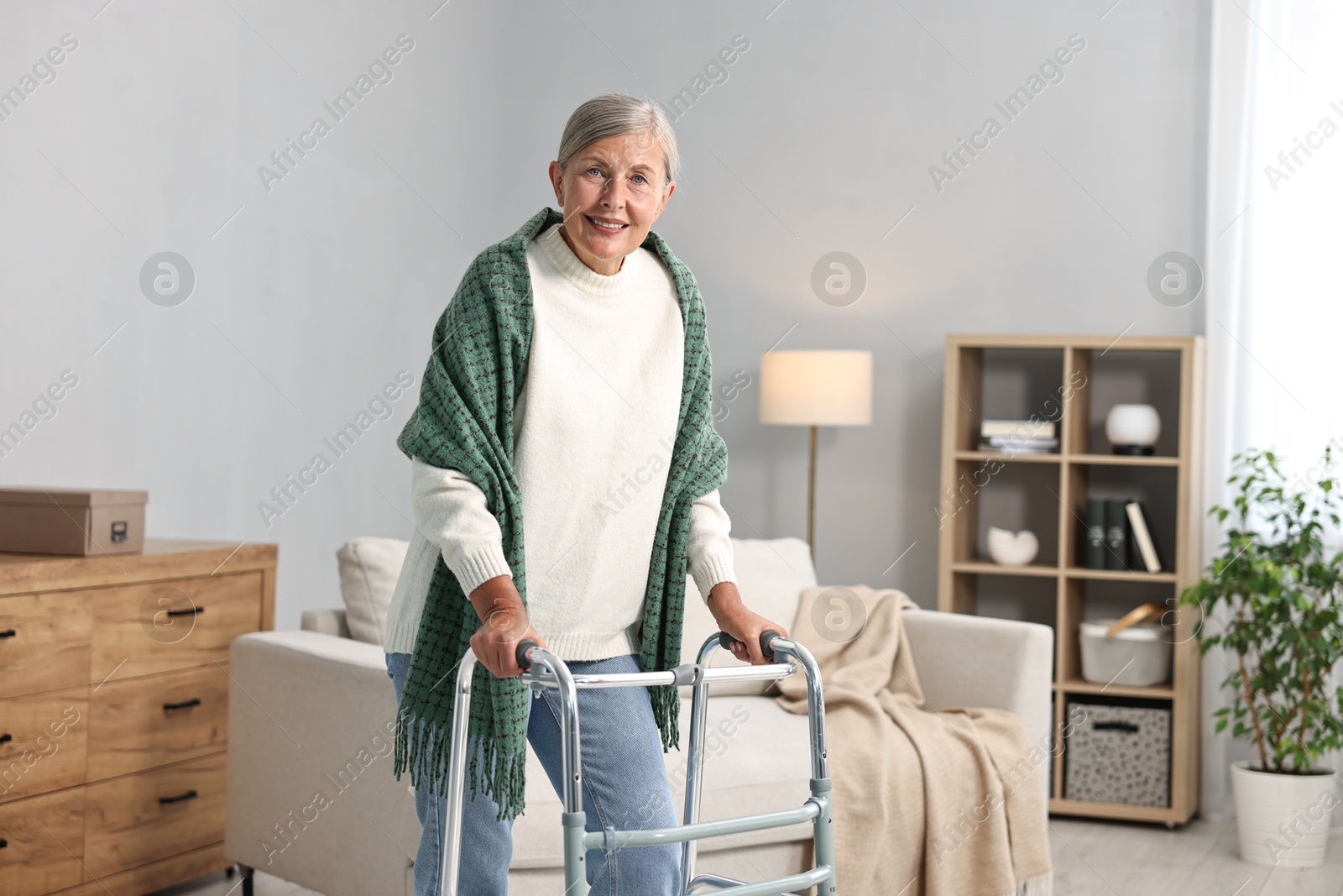 Photo of Senior woman with walking frame at home