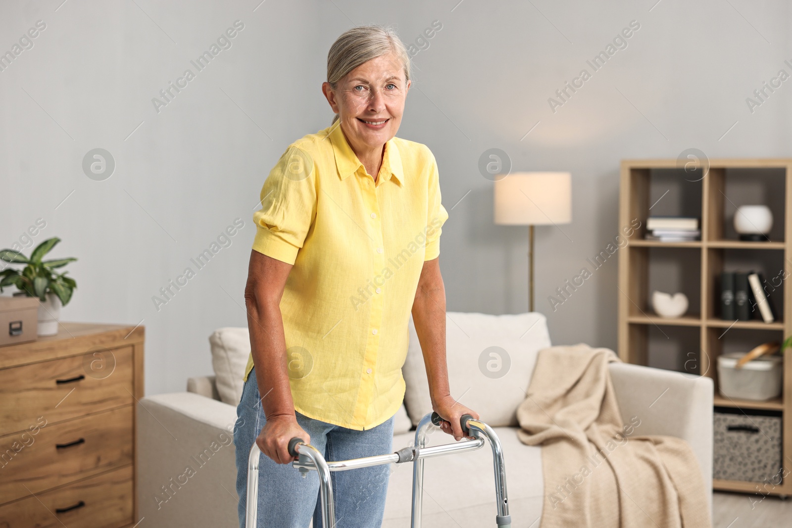 Photo of Senior woman with walking frame at home