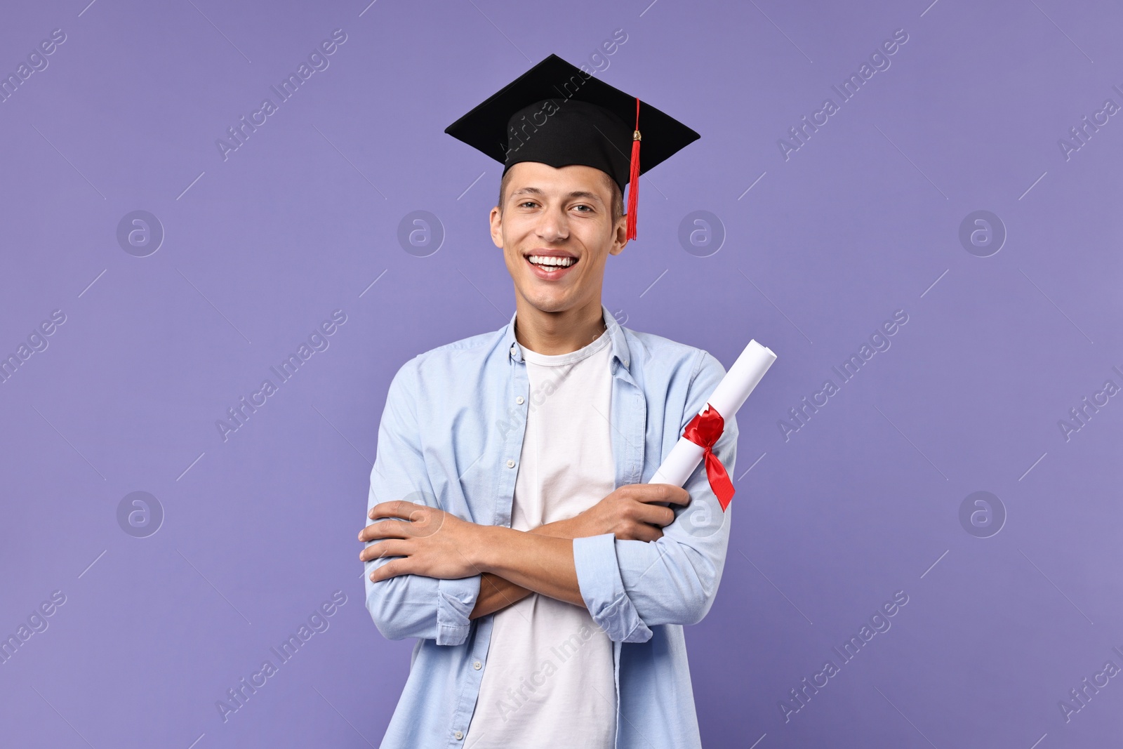 Photo of Happy student with diploma after graduation on violet background