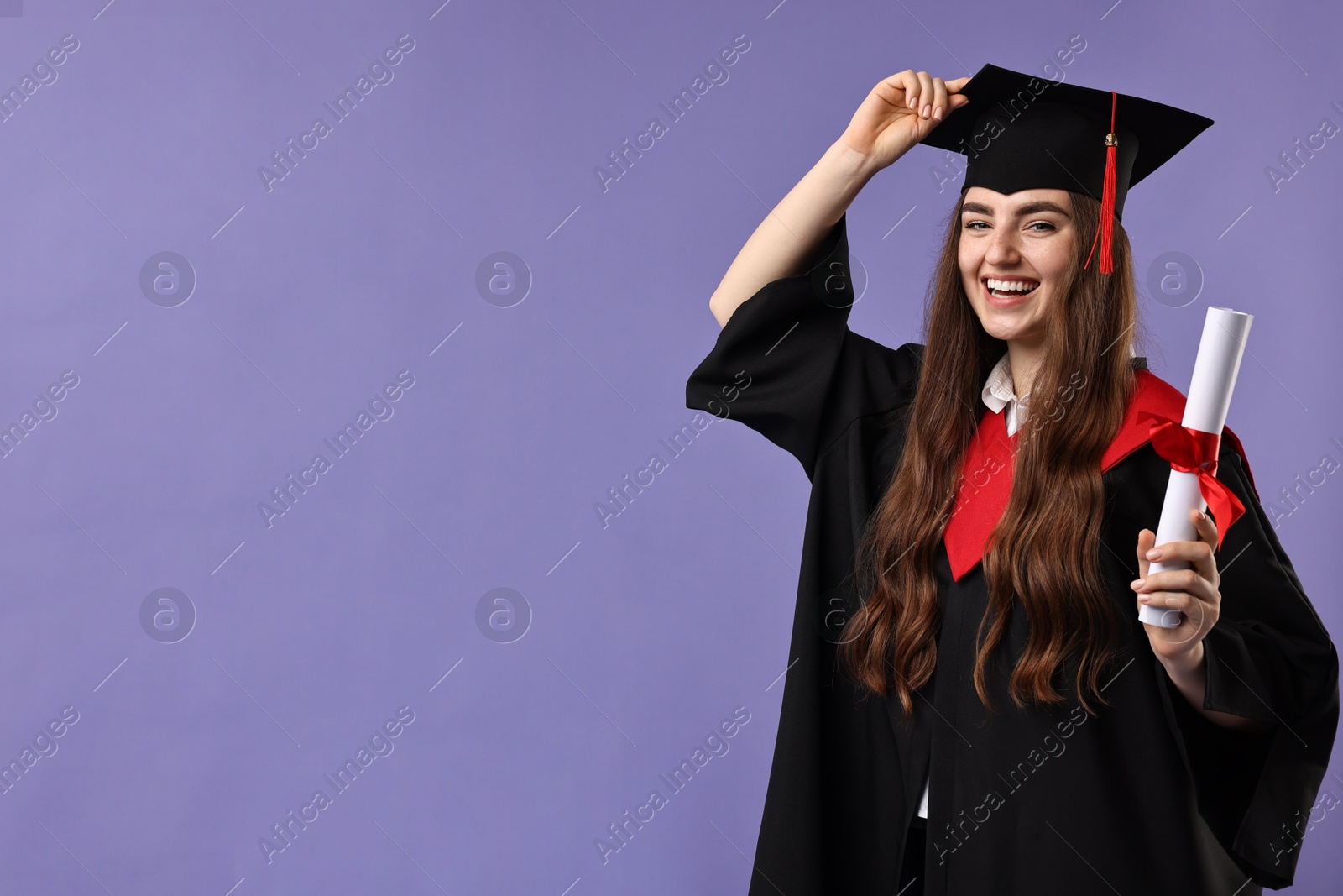 Photo of Happy student with diploma after graduation on violet background. Space for text