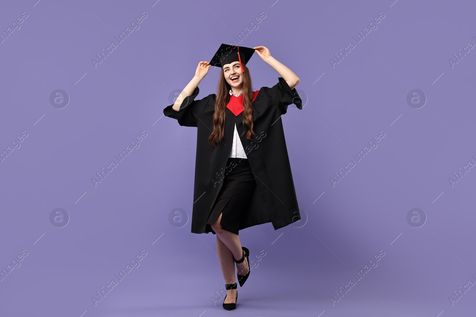 Photo of Happy student after graduation on violet background