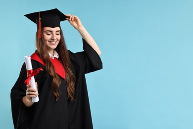 Photo of Happy student with diploma after graduation on light blue background. Space for text