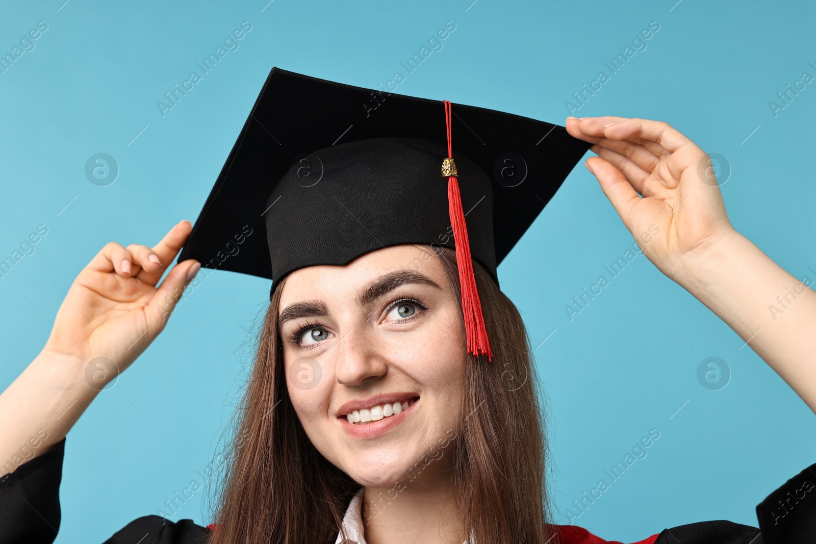 Photo of Happy student after graduation on light blue background