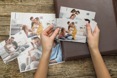 Photo of Woman with different photos and photo album at wooden table, top view