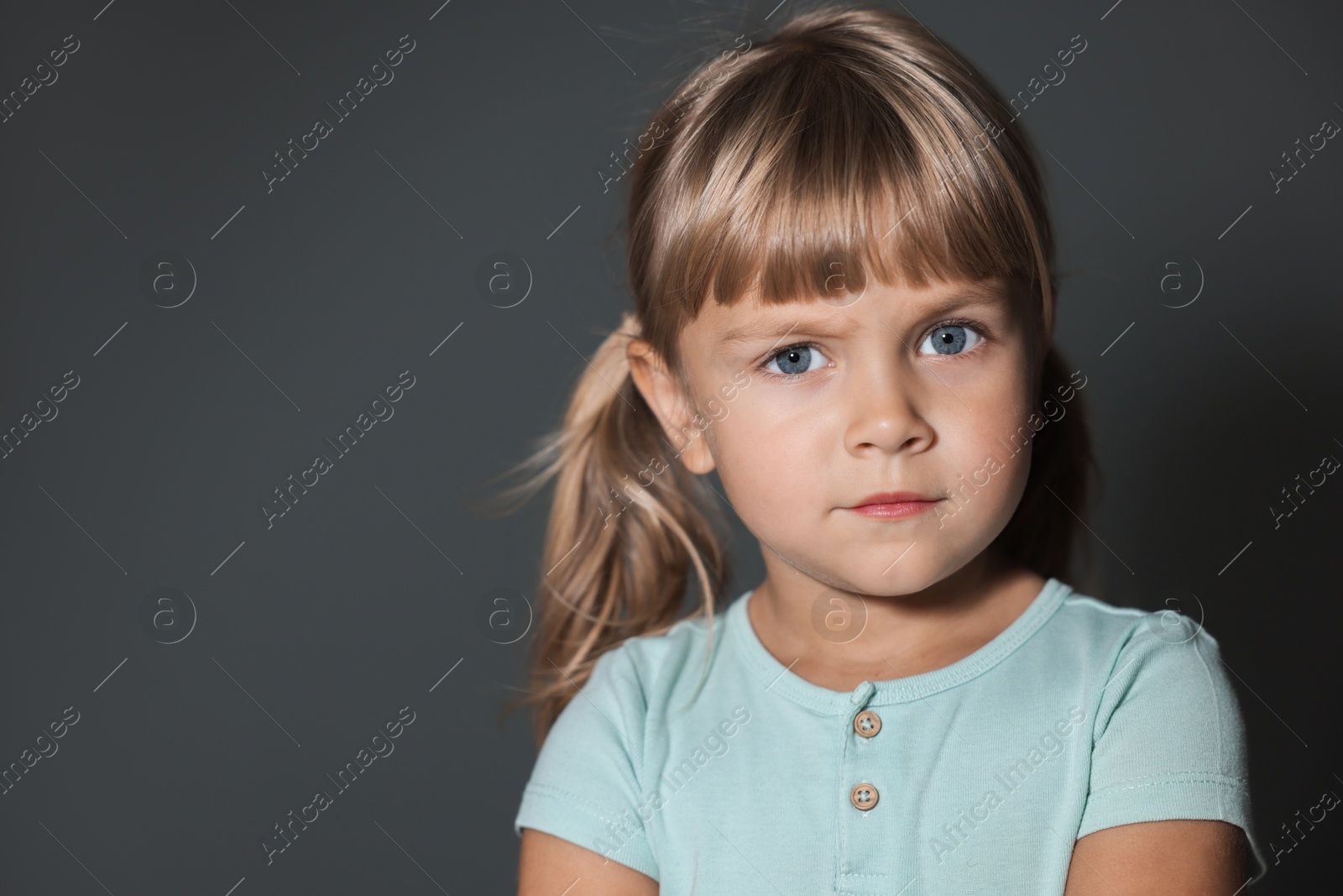 Photo of Orphanage concept. Sad little girl on grey background, space for text