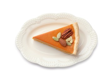 Photo of Piece of tasty homemade pumpkin pie with seeds and nuts isolated on white, top view