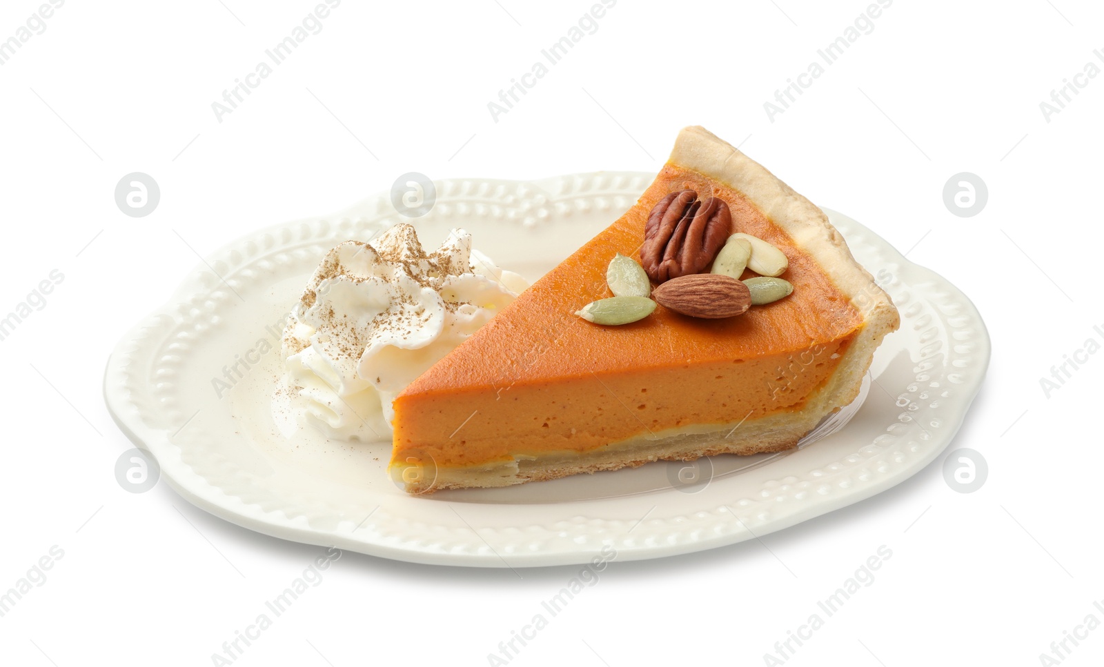 Photo of Piece of tasty homemade pumpkin pie with whipped cream, seeds and nuts isolated on white