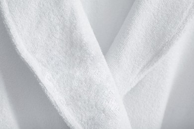 Photo of Clean terry bathrobe as background, closeup view