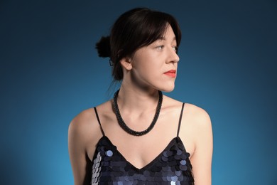 Photo of Portrait of beautiful young woman on blue background