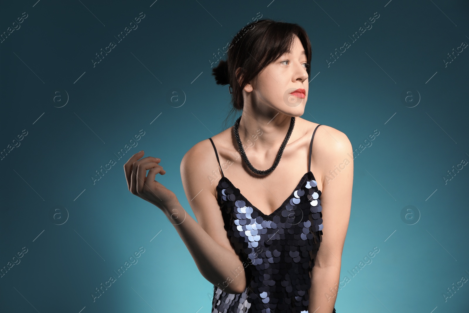 Photo of Beautiful young woman posing on blue background