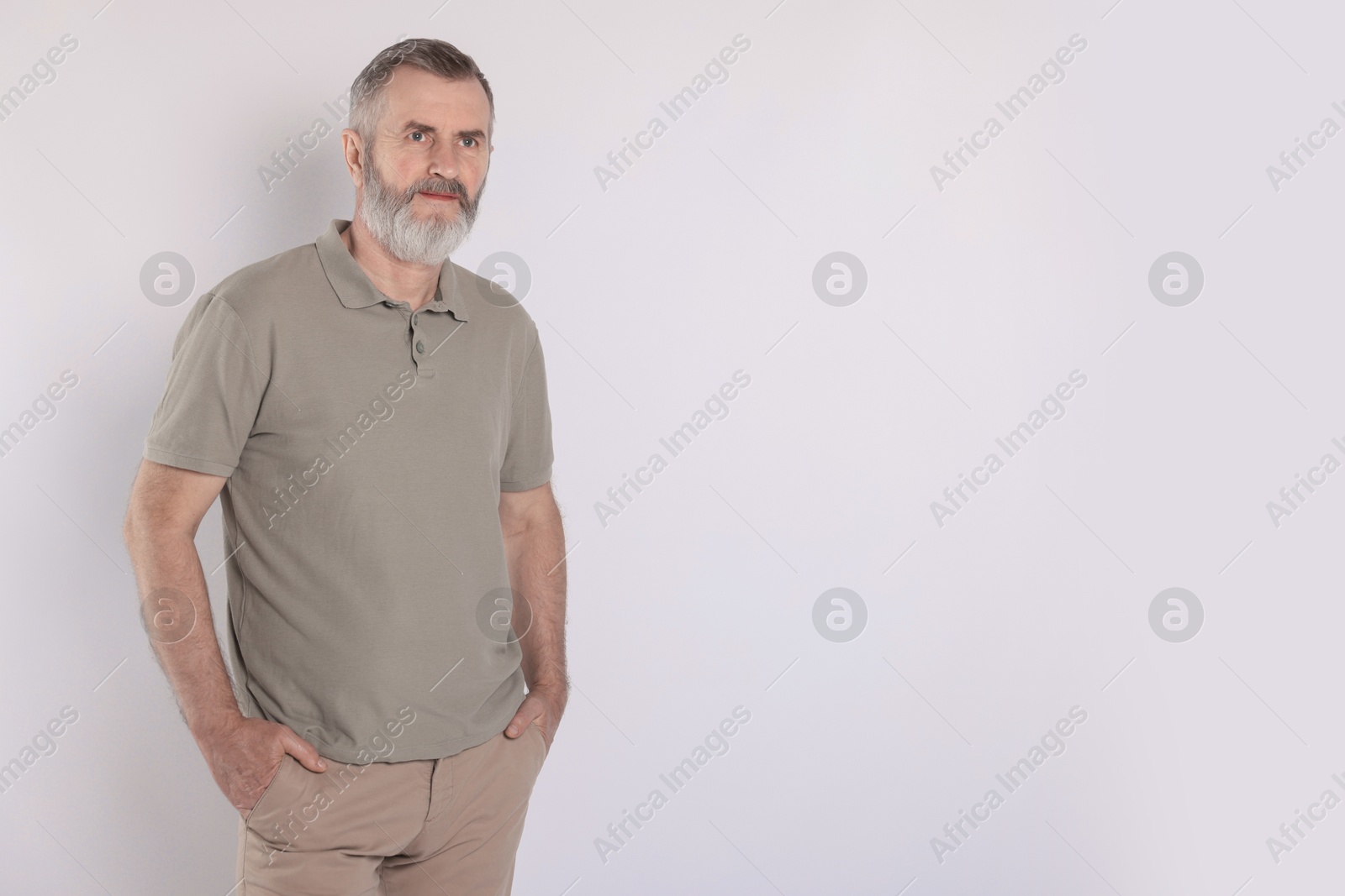 Photo of Portrait of senior man on white background, space for text