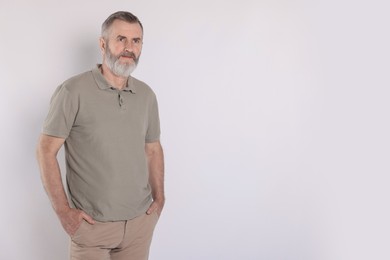 Photo of Portrait of senior man on white background, space for text