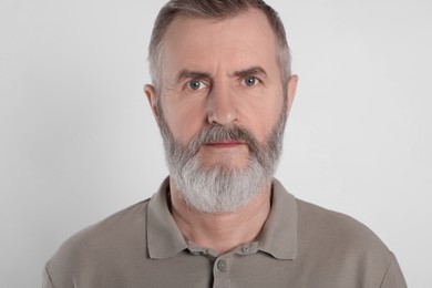 Photo of Portrait of senior man on white background