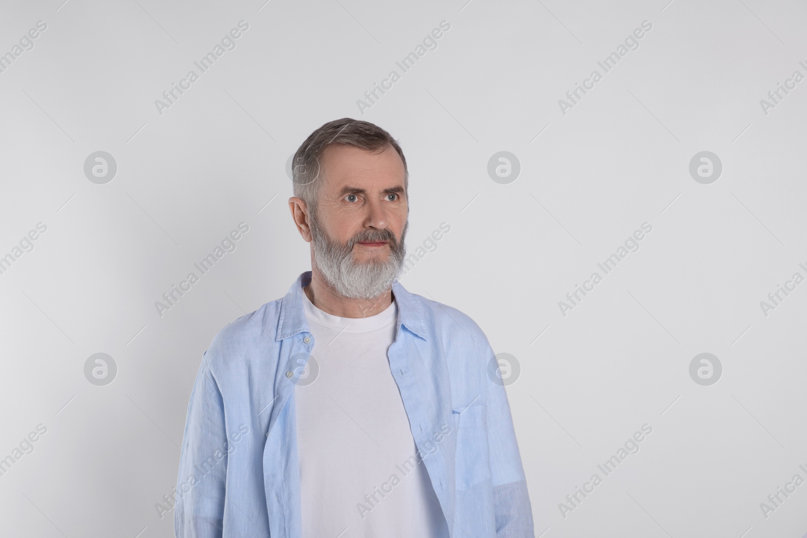 Photo of Portrait of senior man on white background