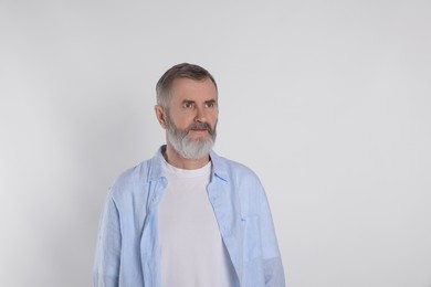 Photo of Portrait of senior man on white background