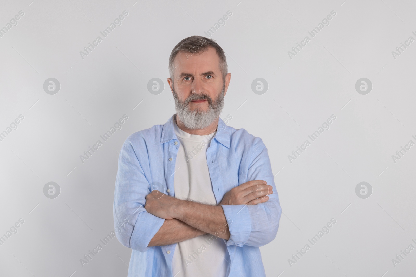 Photo of Portrait of senior man on white background