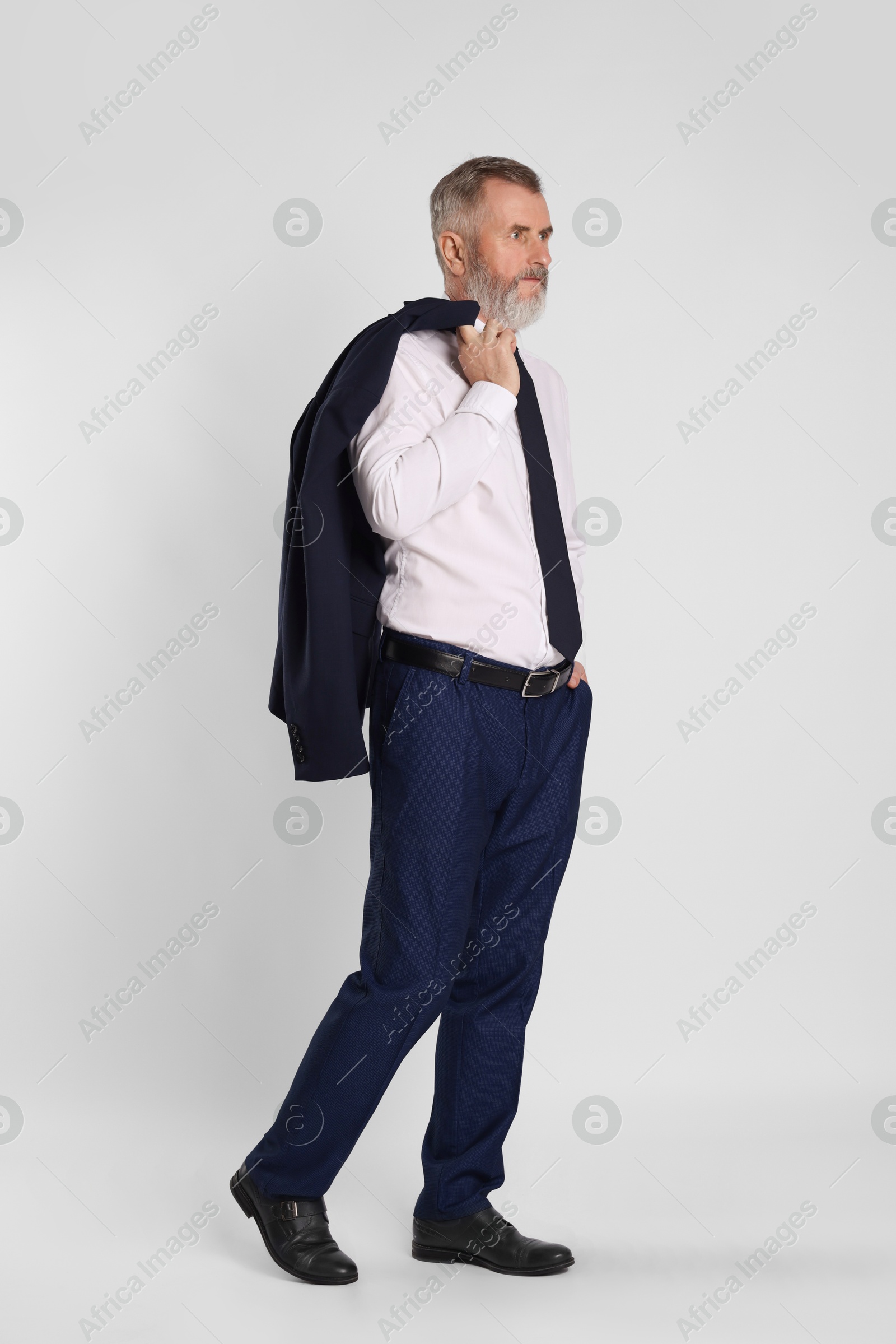 Photo of Portrait of senior man in suit on white background