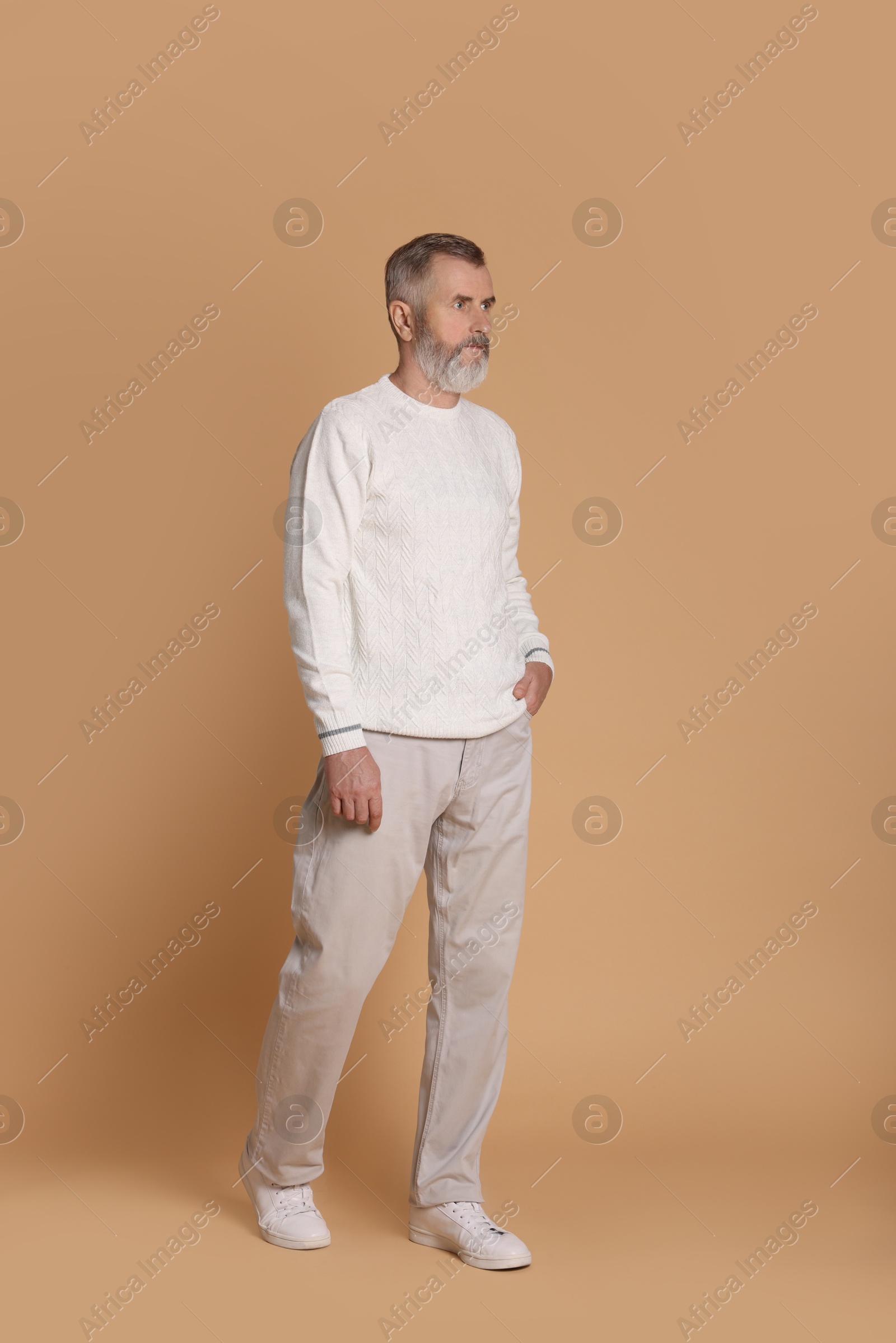 Photo of Portrait of senior man on beige background