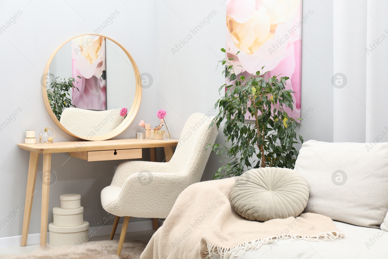 Photo of Mirror, dressing table, houseplant, sofa and armchair indoors. Interior design