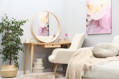 Photo of Mirror, dressing table, houseplant, sofa and armchair indoors. Interior design