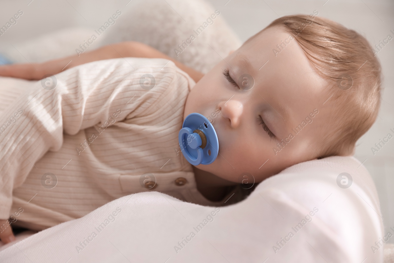 Photo of Mother with her sleeping baby in armchair, closeup