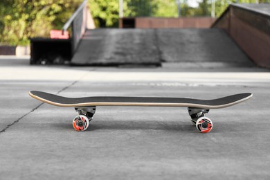 Photo of One modern skateboard with black griptape in skatepark