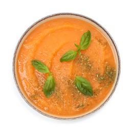 Photo of Delicious sweet potato soup with basil in bowl isolated on white, top view