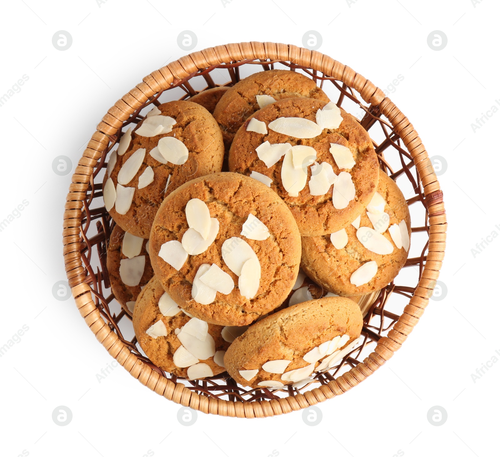 Photo of Tasty cookies with almond flakes in wicker basket isolated on white, top view