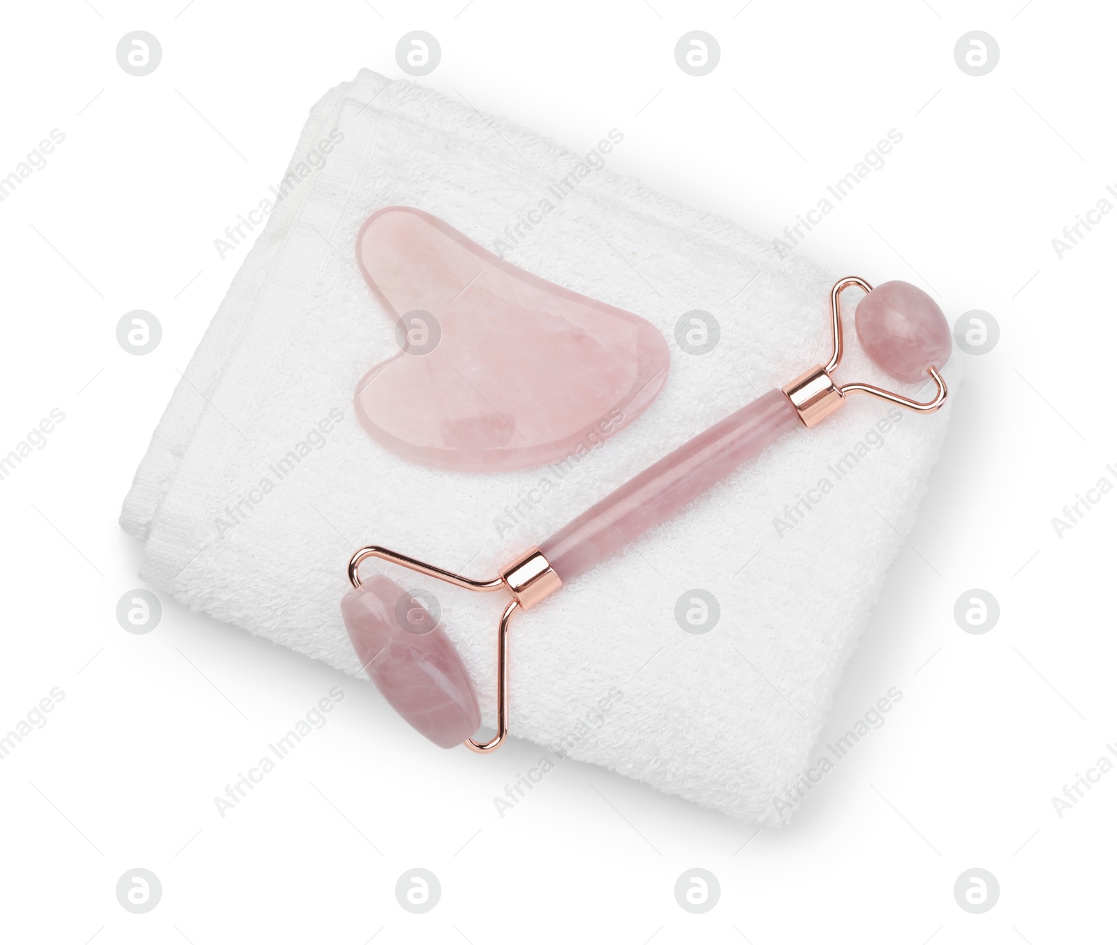 Photo of Face roller, gua sha tool and towel isolated on white, top view