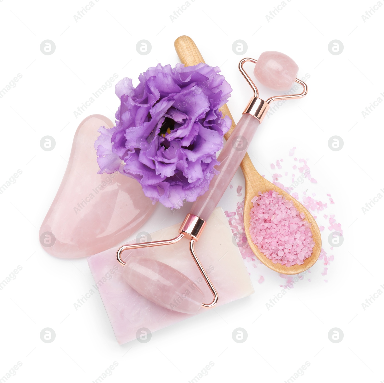 Photo of Face roller, soap, gua sha, sea salt and flower isolated on white, top view