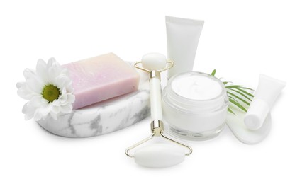 Face roller, cosmetic products, soap, gua sha and flower isolated on white