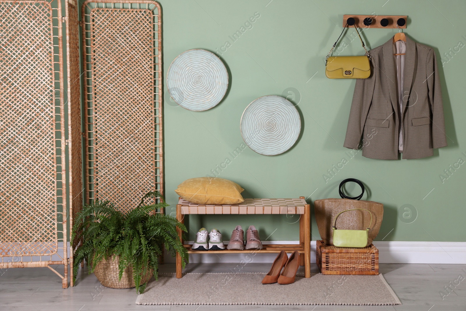 Photo of Stylish hallway interior with bench and folding screen