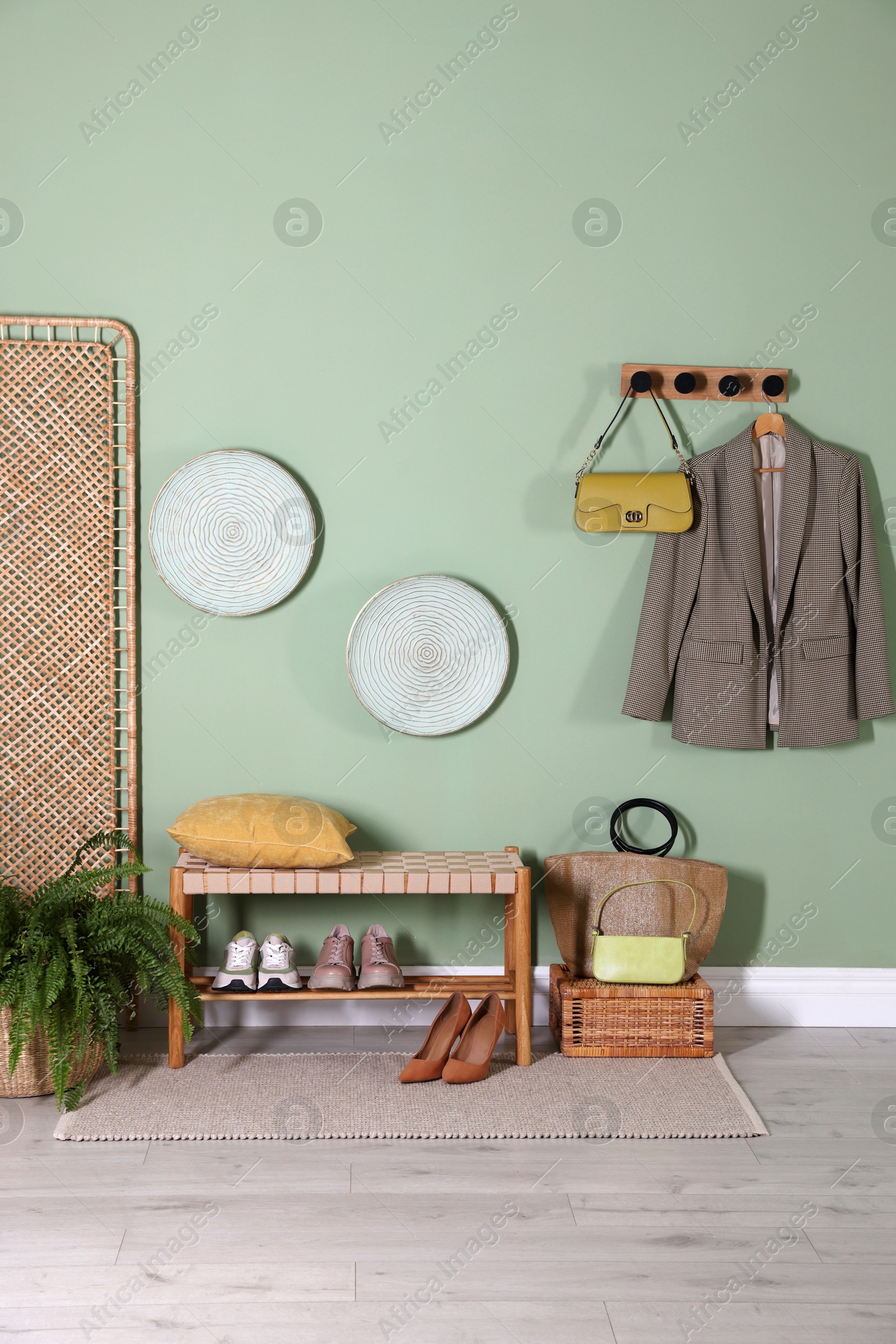 Photo of Stylish hallway interior with bench and folding screen