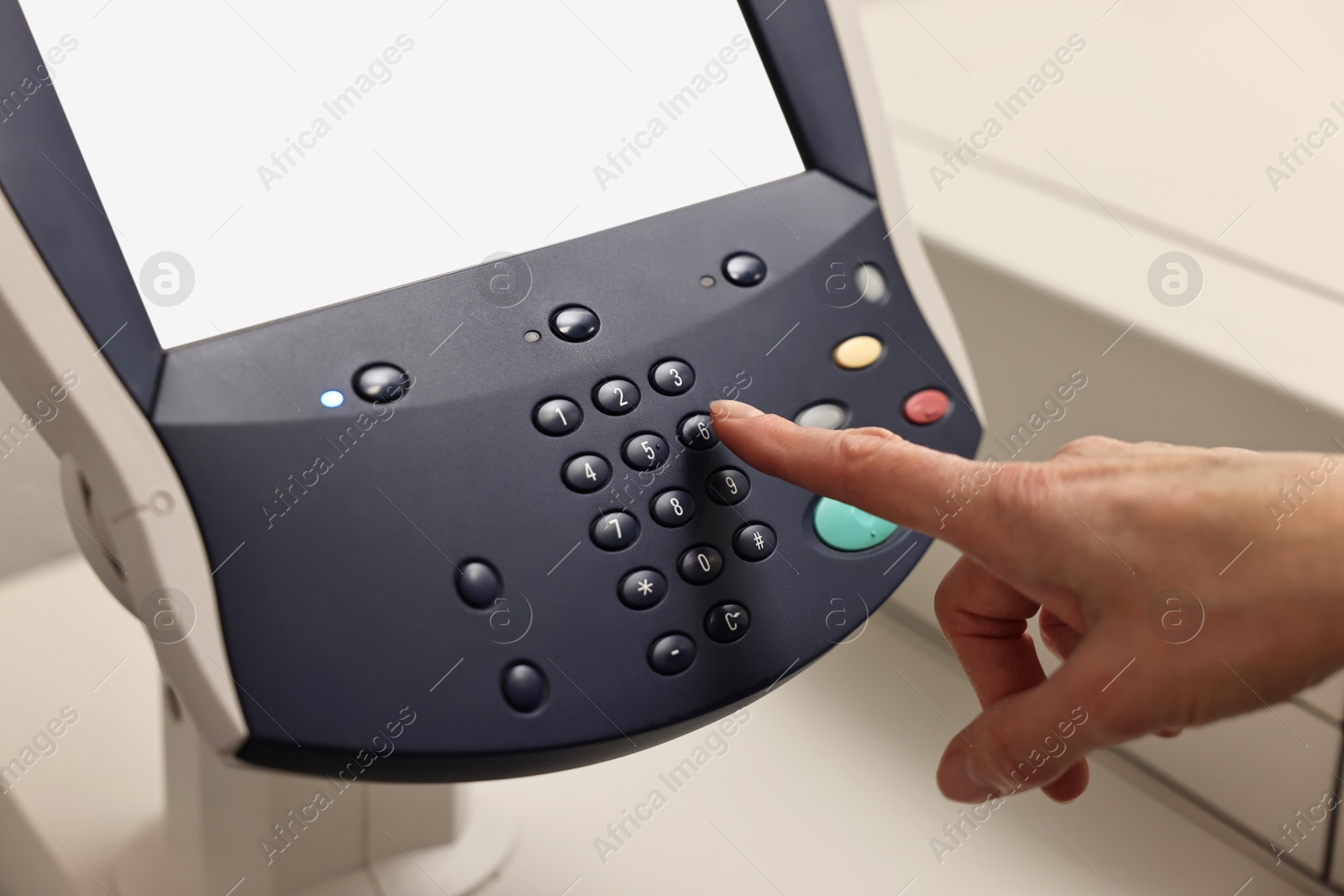 Photo of Woman using modern printer indoors, closeup. Printing house