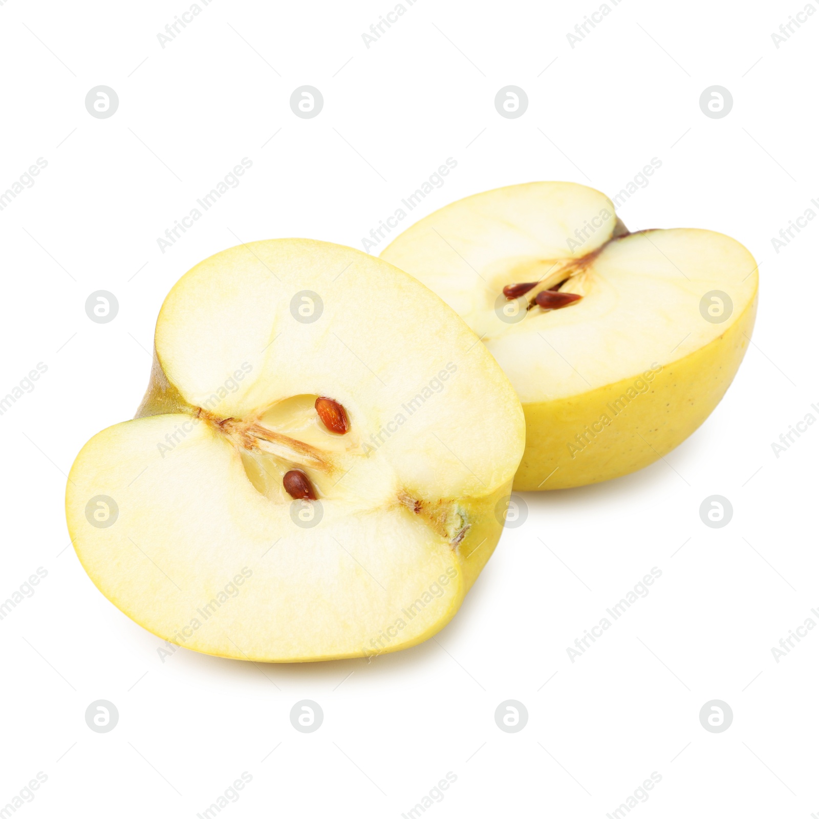 Photo of Halves of ripe yellow apple isolated on white