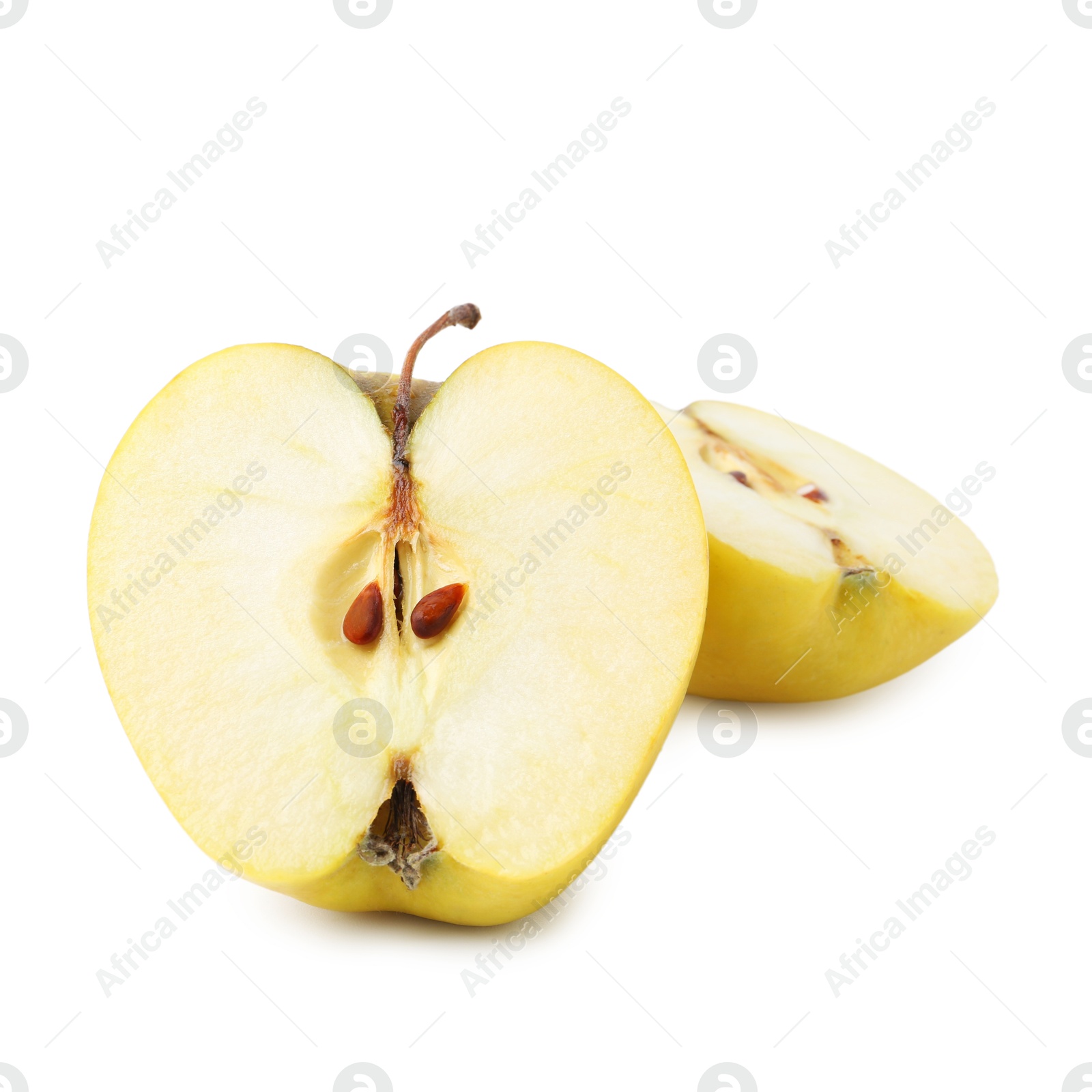 Photo of Halves of ripe yellow apple isolated on white