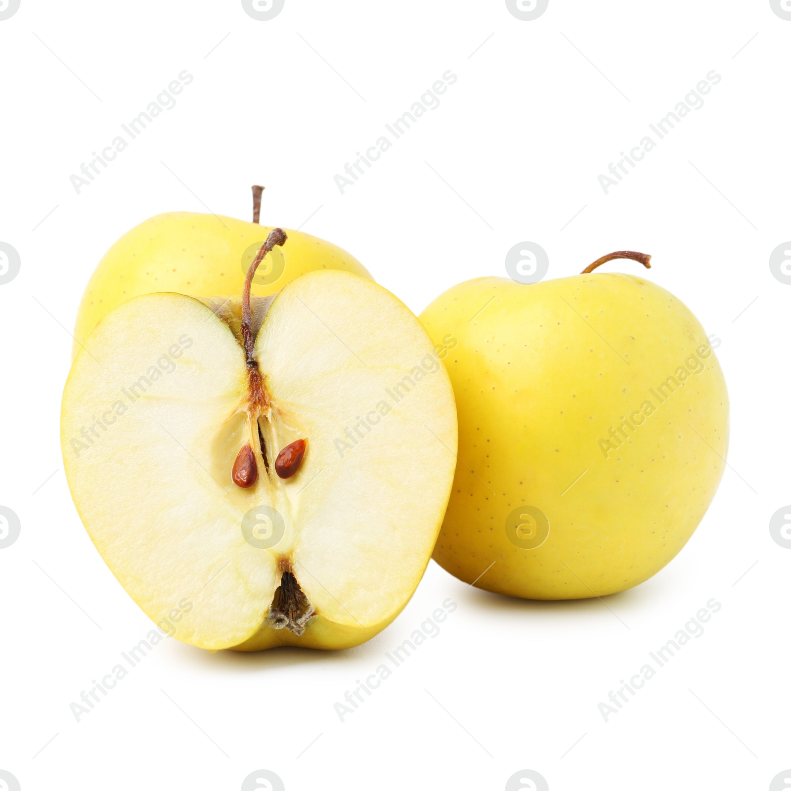 Photo of Whole and cut ripe yellow apples isolated on white