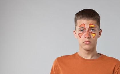 Image of Man suffering from sinusitis on light grey background, space for text. Illustration on his face showing disease