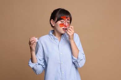 Image of Woman suffering from sinusitis on dark beige background. Illustration on her face showing disease