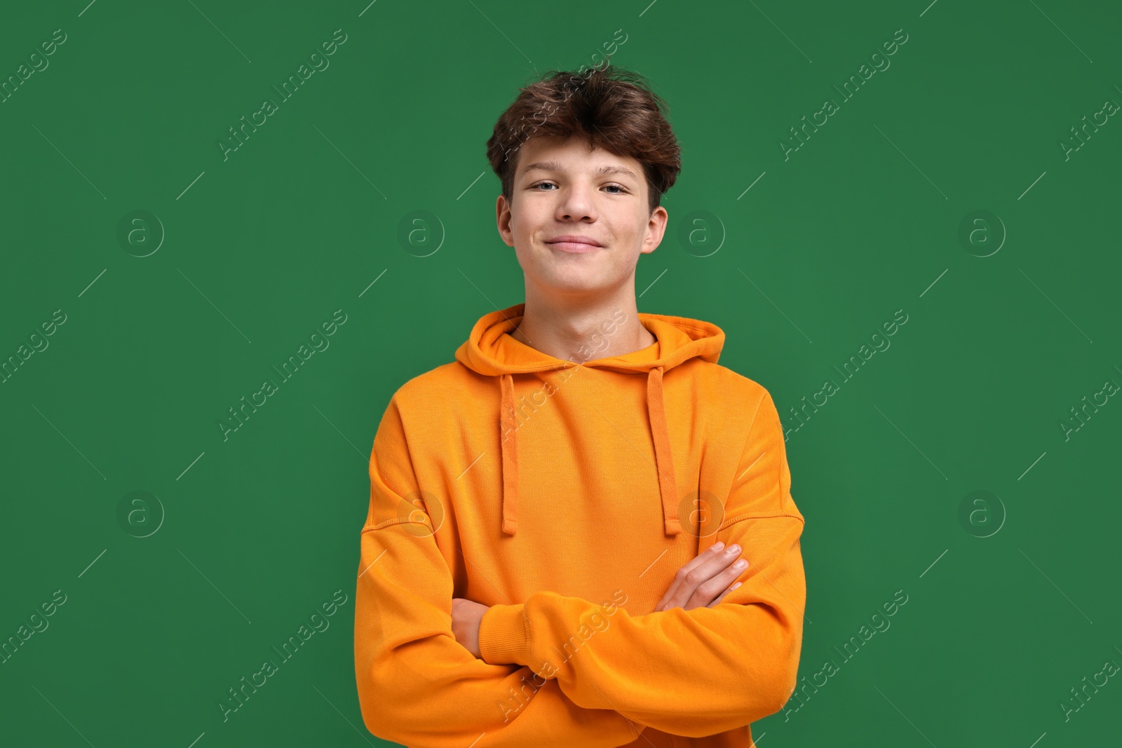 Photo of Portrait of happy teenage boy on green background