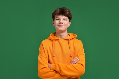 Photo of Portrait of happy teenage boy on green background