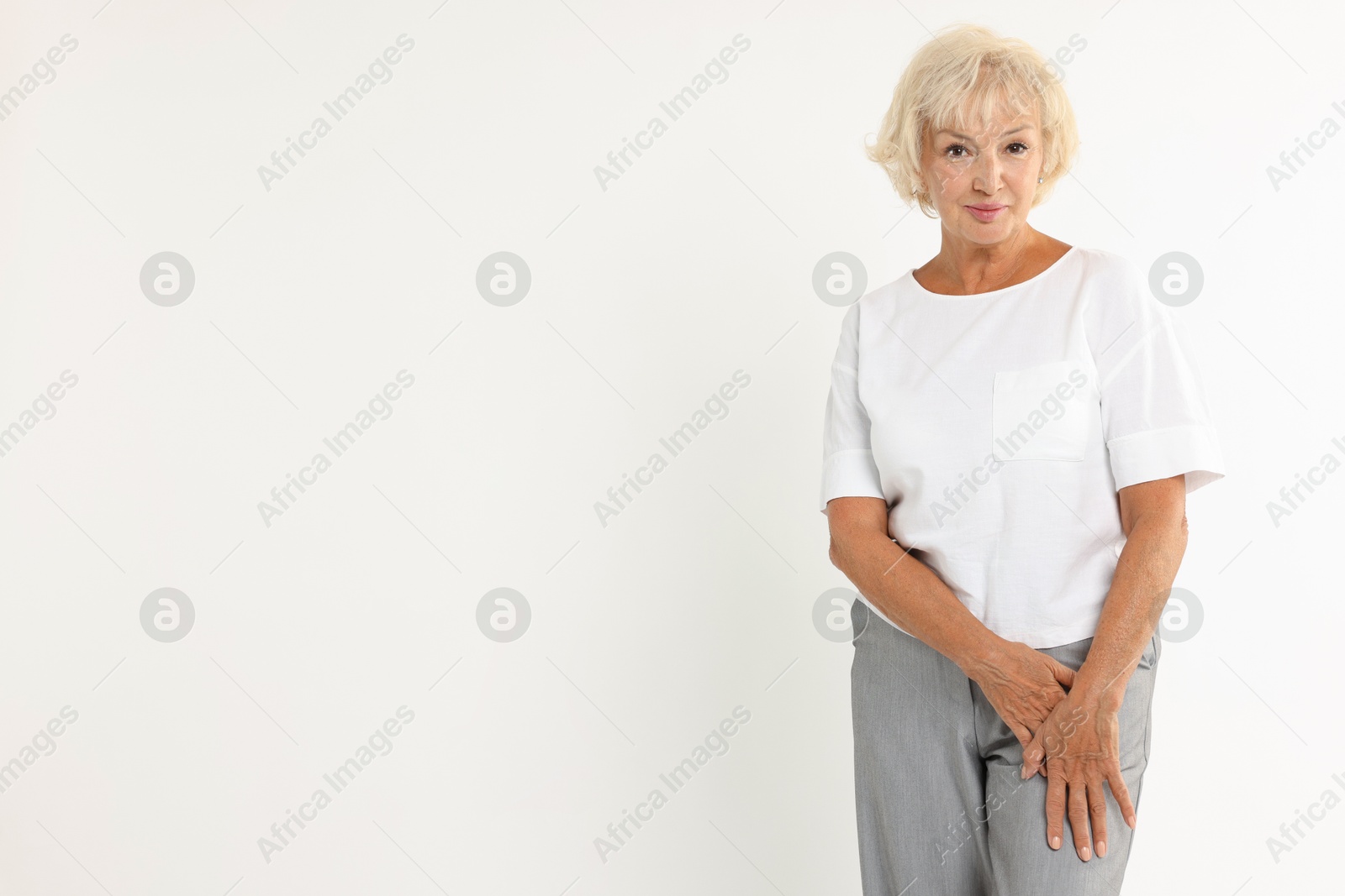 Photo of Portrait of beautiful senior woman on white background, space for text