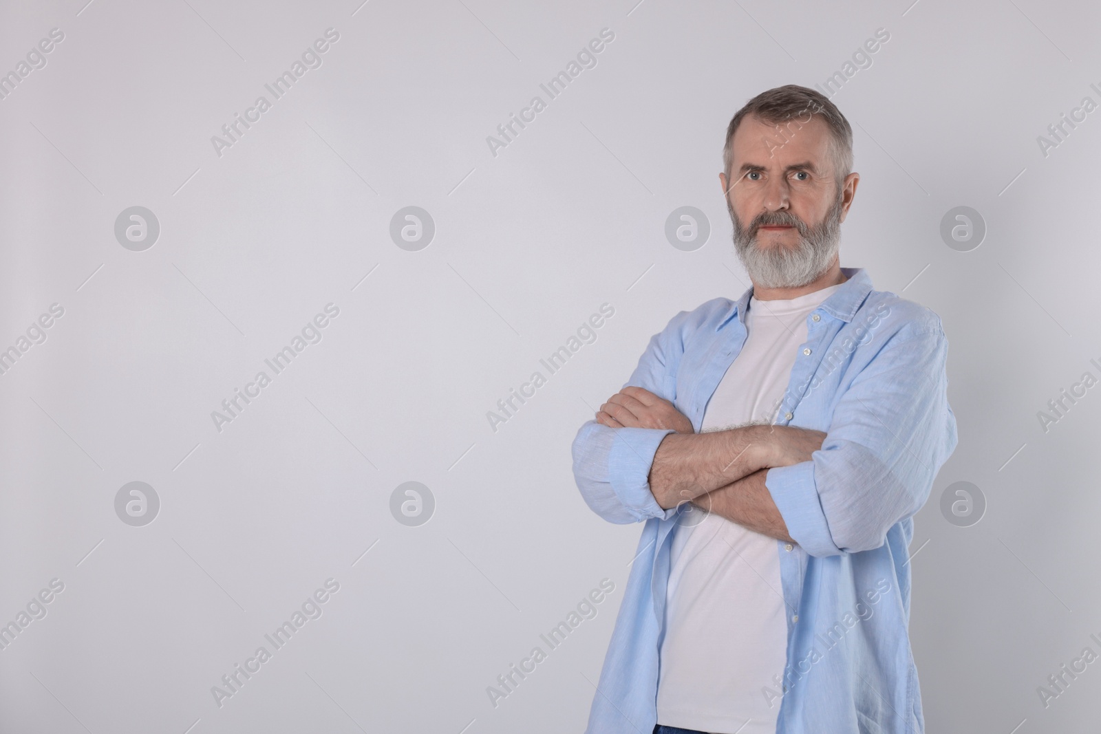 Photo of Portrait of senior man on white background, space for text