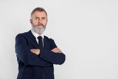 Photo of Portrait of senior man in suit on white background, space for text